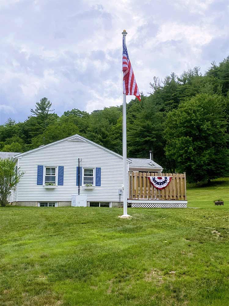 Flagpole in green lawn.