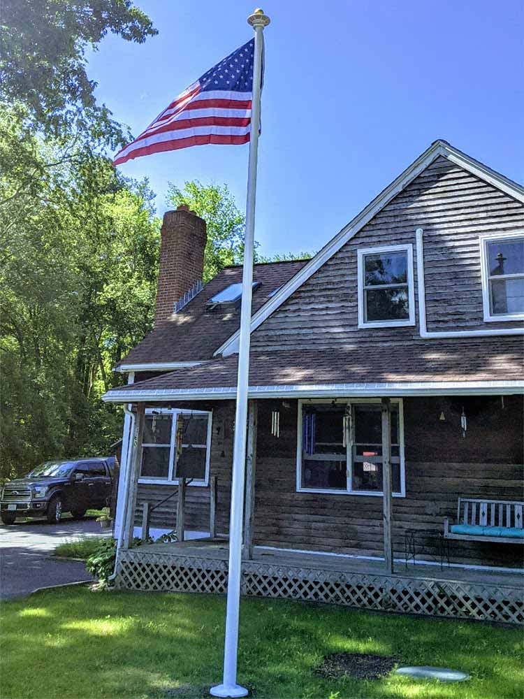 Flagpole in front of a residential property.