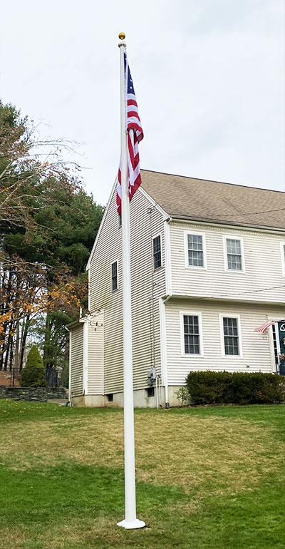 flagpole in front of house.