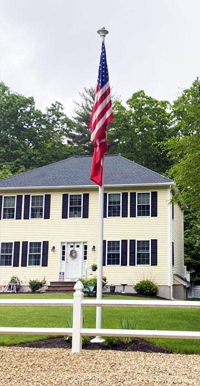 flagpole in front of house.